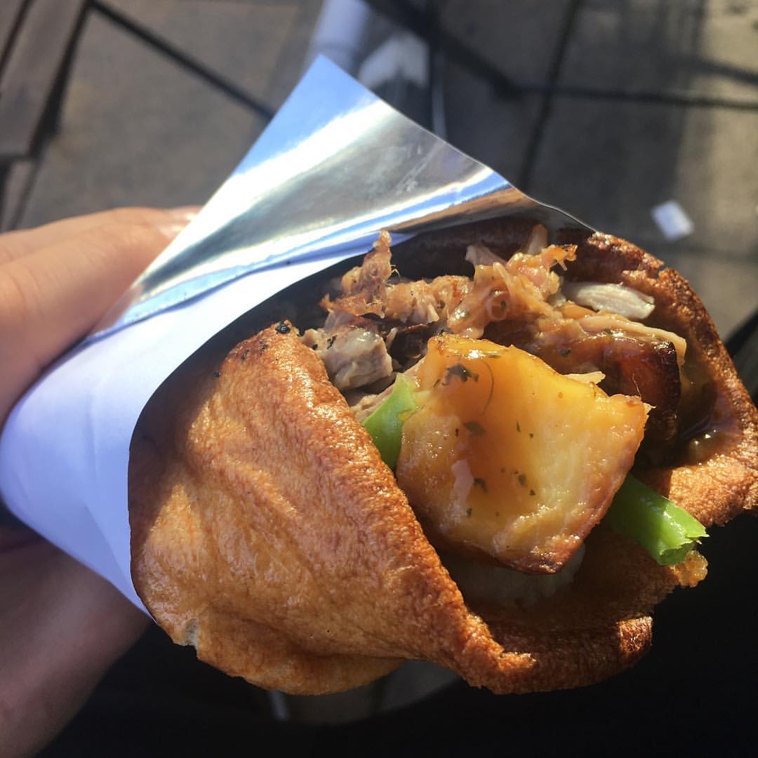 3 different roast meats, potatoes, veg, and gravy in a giant Yorkshire pudding